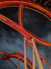 Low angle view of illuminated ferris wheel against sky at night