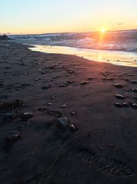 Scenic view of beach against sky during sunset