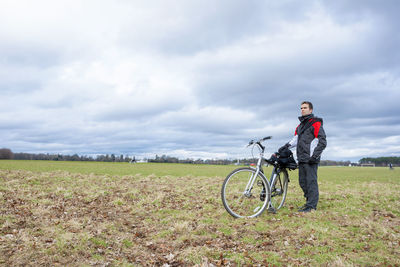 Man riding bicycle on field