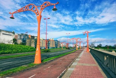 Street light by road against sky