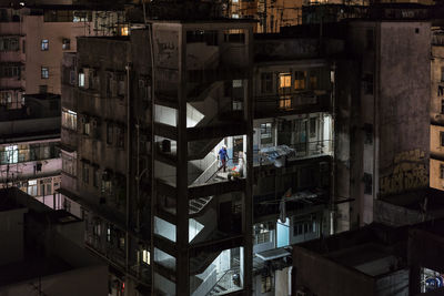 High angle view of residential buildings in city at night