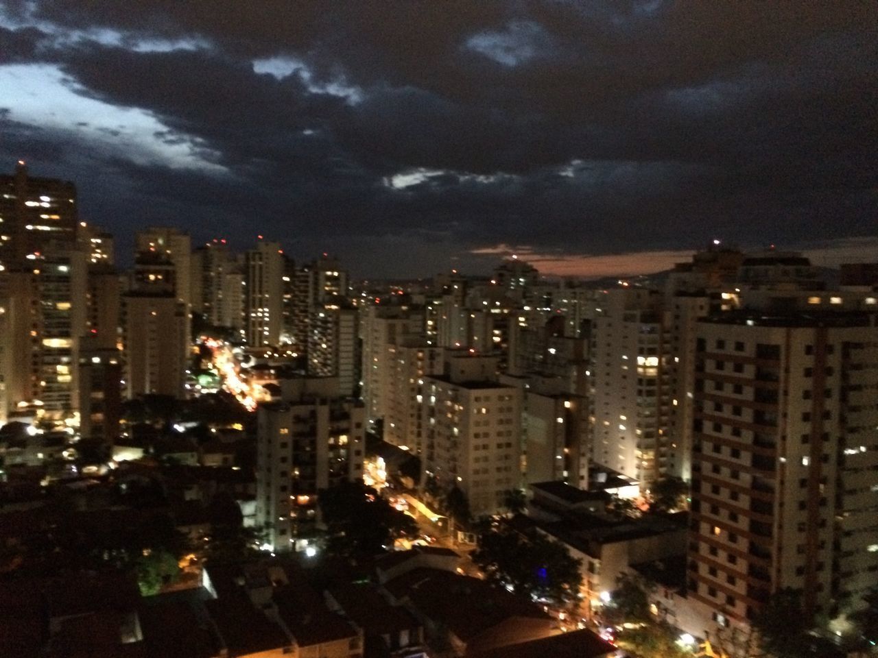 ILLUMINATED CITYSCAPE AGAINST SKY AT NIGHT