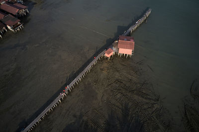 High angle view of illuminated pier on beach