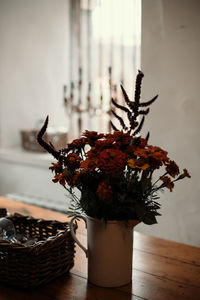 Close-up of potted plant on table against wall