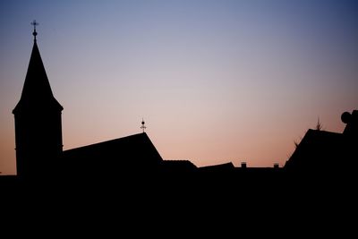 Low angle view of silhouette buildings against sky during sunset