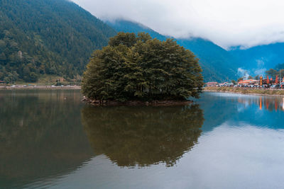 Scenic view of lake and mountains against sky