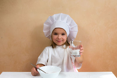 High angle view of girl with umbrella on table
