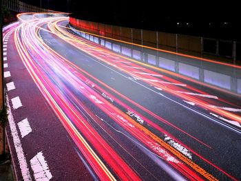 High angle view of light trails on highway at night