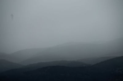 Scenic view of silhouette mountains against sky