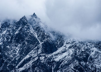 Close-up of mountains against sky during winter