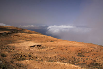 Scenic view of arid landscape against sky