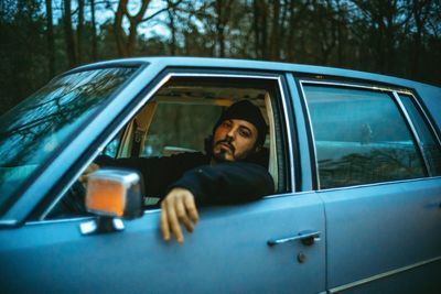 Portrait of man sitting in car