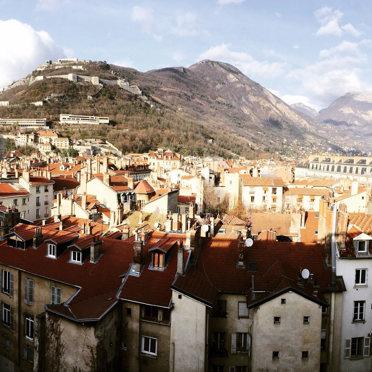 building exterior, architecture, built structure, mountain, house, residential structure, residential district, residential building, townscape, town, roof, high angle view, crowded, sky, mountain range, cityscape, community, city, human settlement, old town