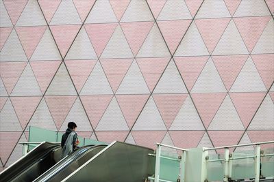 Man moving up on escalator