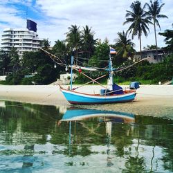 Boat moored on sea against sky