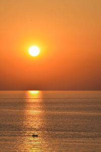 Scenic view of sea against orange sky