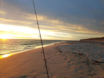 Scenic view of beach against sky during sunset