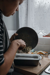 Midsection of man preparing food at home