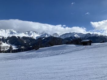 Scenic view of snow covered mountains against sky