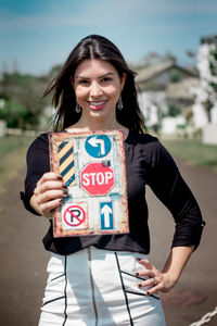 Portrait of a smiling young woman standing outdoors