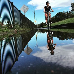 Reflection of man in puddle