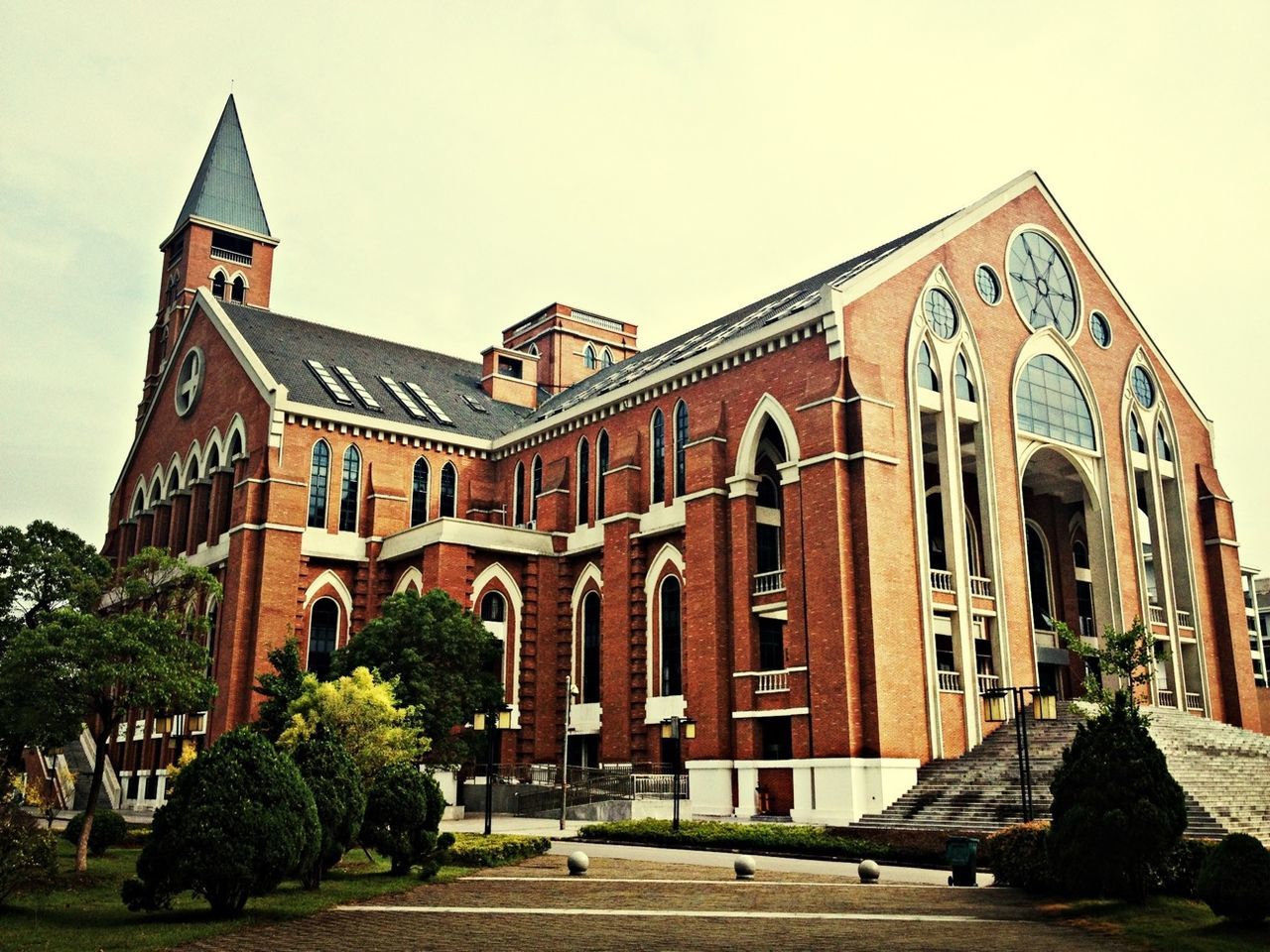 architecture, built structure, building exterior, sky, facade, clear sky, arch, city, low angle view, tree, history, incidental people, day, street, outdoors, road, travel destinations, no people, exterior, building