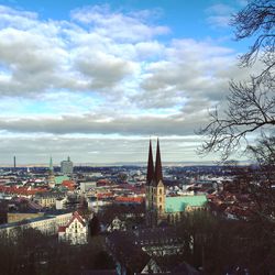 Cityscape against cloudy sky