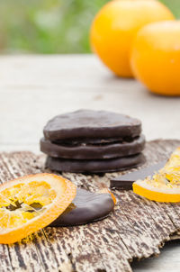 Close-up of chocolates with oranges on table