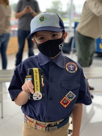 Portrait of boy wearing uniform standing outdoors