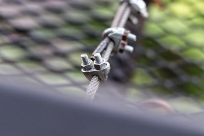 Close-up of padlock hanging on rope