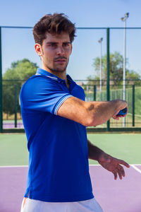 Man playing tennis on court