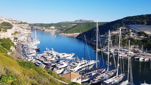 High angle view of marina by river against sky
