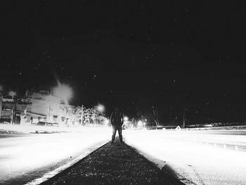 Road along trees at night