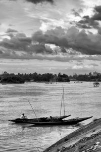 Sailboats in sea against sky
