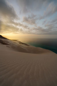 Scenic view of desert against sky during sunset