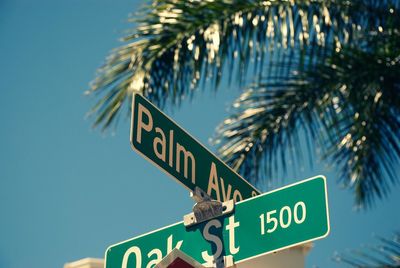 Low angle view of road sign against sky