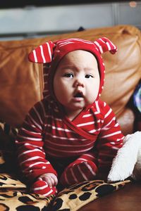 Close-up portrait of cute girl at home