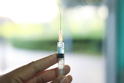 Cropped hand holding syringe in hospital