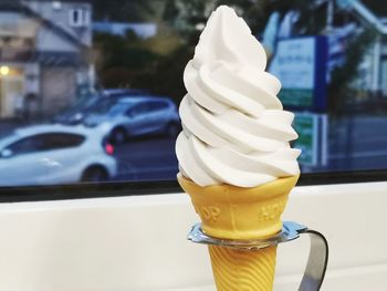 Close-up of ice cream on glass table