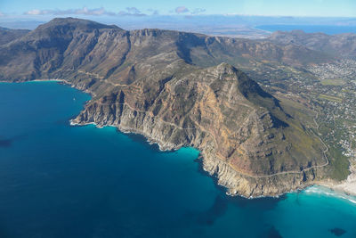 High angle view of sea and mountains against sky