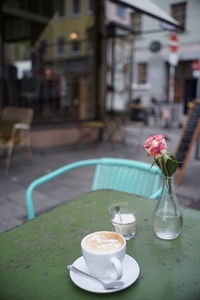 Coffee served on table at a cafe terrace with vintage furniture 
