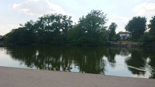 Scenic view of lake by building against sky