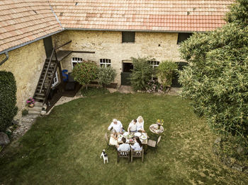 Family eating together in the garden in summer