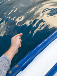 High angle view of hand on boat in sea