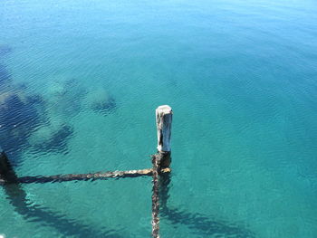 High angle view of rope tied on wooden post