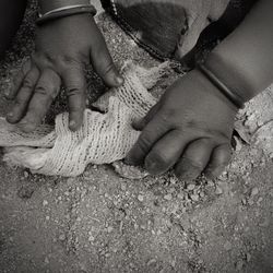 High angle view of woman hands on land