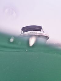 Close-up of electric lamp against sky