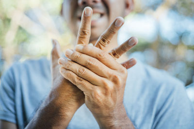 Close-up of man holding hands