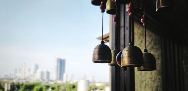 See through the window - close up of wind chime hanging against beautiful sky