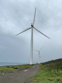 Low angle view of windmill against sky